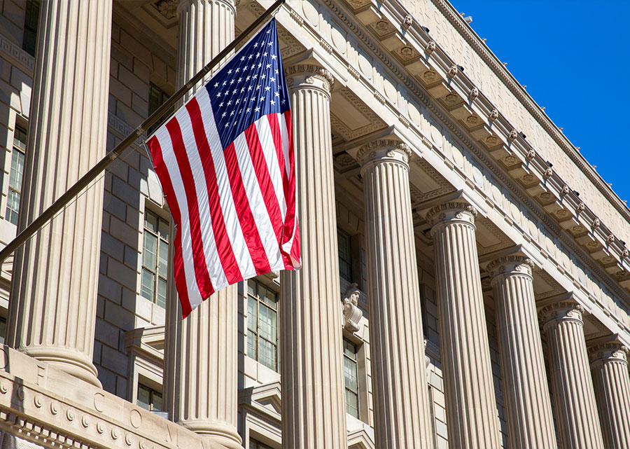 exterior of an American government building with american flag